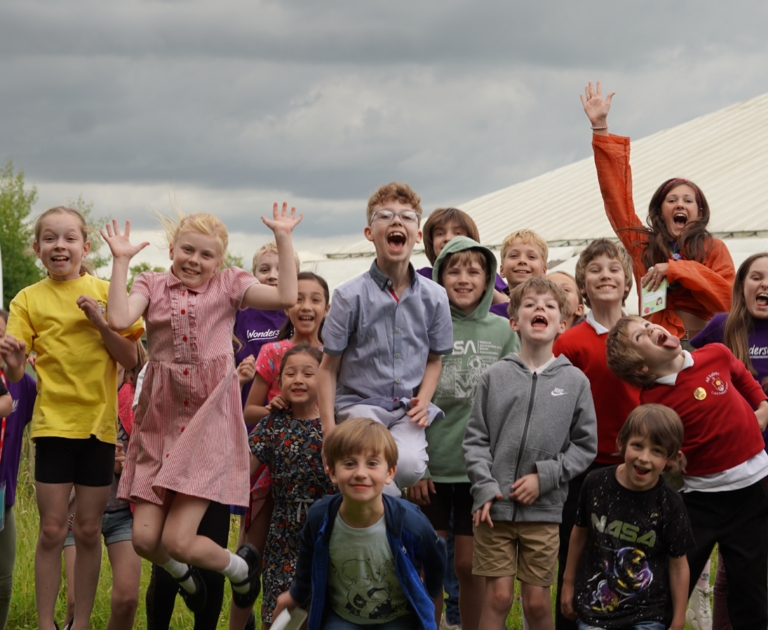 Children jumping in the air while smiling and laughing