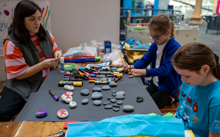 children decorating rocks with artist Milly Rolle