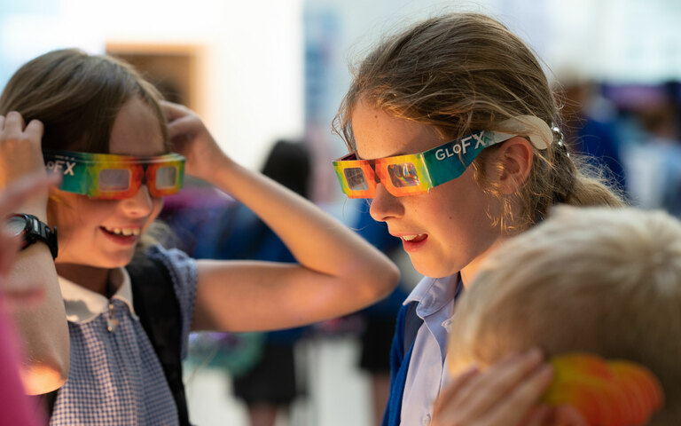 Two girls wearing science refraction glasses