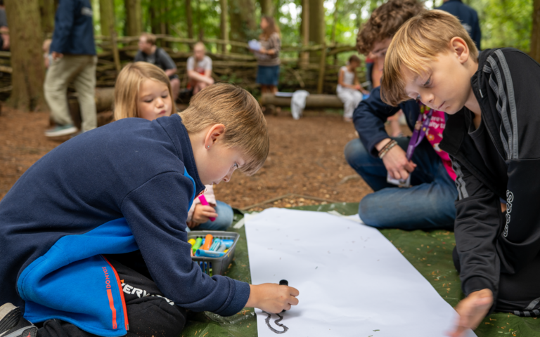 Children drawing and colouring as part of mark making